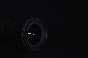 Optics to the camera on the operator’s desk. Flare in the glass of a photo lens. Background with the technique of the photographer.