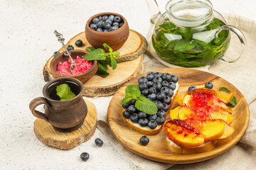 Tasty toast bread with cream cheese and ripe fruits
