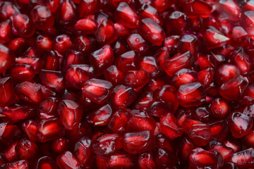Full frame macro shot background of pomegranate peeled ripe seeds
