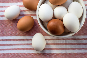 Chicken eggs. Breakfast ingredient on a colored tea towel. Top and side views. Selective focus. Blurred backdrop.