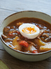 vegetable and mushroom stew and half a poached egg on top