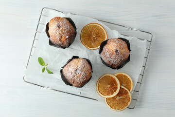 Concept of delicious food with chocolate muffins on white wooden table