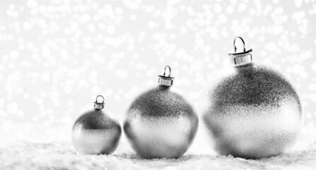 Glitter silver Christmas balls on snow