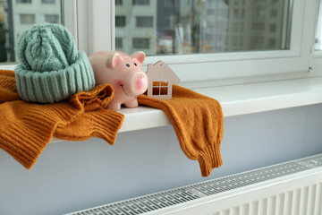 Concept of heating season with clothes on windowsill