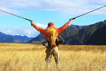 Fototapeta na wymiar trekking mountains man walking sticks travel adventure man with backpack