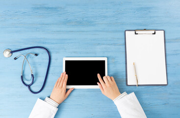 Top view of doctor hands with tablet computer