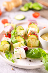 vegetables grilled on stick and dipping sauce