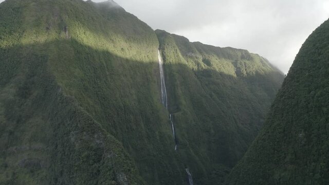 Aerial view of a waterfall (La Cascade Blanche) among the mountain landscape near Saint Andr&egrave;, Saint Benoit, Reunion.