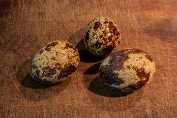 Quail eggs on the table. Several spotted quail eggs. Food