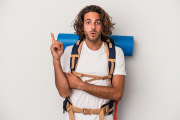 Young hiker caucasian man isolated on gray background having some great idea, concept of creativity. © Asier
