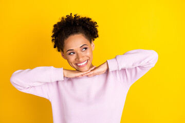 Photo of young happy beautiful dark skin woman look empty space hands face teeth white isolated on yellow color background