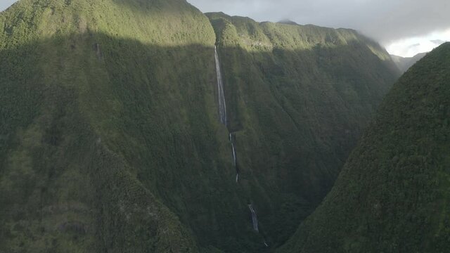 Aerial view of a waterfall (La Cascade Blanche) among the mountain landscape near Saint Andr&egrave;, Saint Benoit, Reunion.