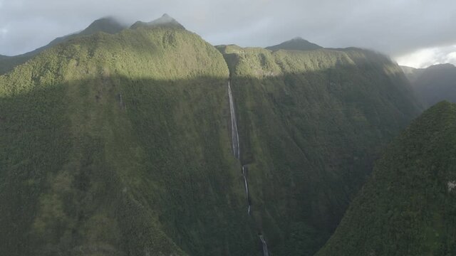 Aerial view of a waterfall (La Cascade Blanche) among the mountain landscape near Saint Andr&egrave;, Saint Benoit, Reunion.