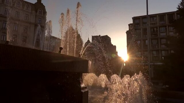 Water fountain in the sunrise light, landmark from the city center of Bucharest, next to Calea Victoriei, 4k video