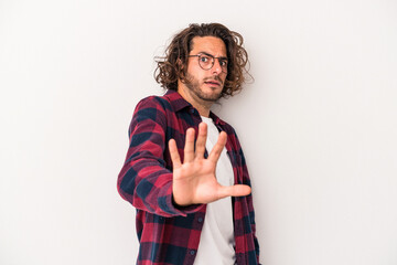 Young caucasian man isolated on white background being shocked due to an imminent danger