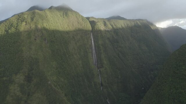 Aerial view of a waterfall (La Cascade Blanche) among the mountain landscape near Saint Andr&egrave;, Saint Benoit, Reunion.