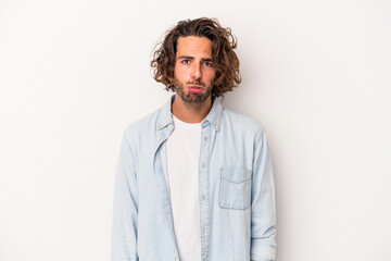 Obraz premium Young caucasian man isolated on white background sad, serious face, feeling miserable and displeased.