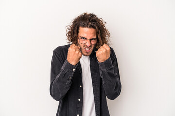 Young caucasian man isolated on white background upset screaming with tense hands.