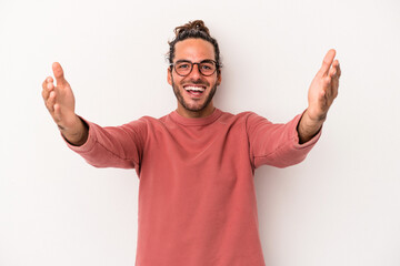Naklejka premium Young caucasian man isolated on white background celebrating a victory or success, he is surprised and shocked.