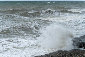 storm on the black sea, waves crashing on the shore, brown water