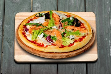 Fresh tasty pizza dish on the desk