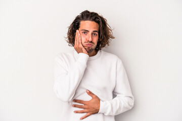 Obraz premium Young caucasian man isolated on gray background blows cheeks, has tired expression. Facial expression concept.