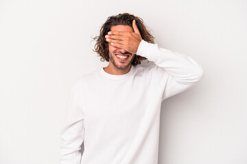 Young caucasian man isolated on gray background covers eyes with hands, smiles broadly waiting for...