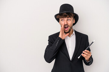 Young arab wizard man holding a wand isolated on white background is saying a secret hot braking...