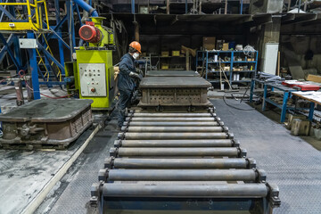 Conveyor belt inside manufacturing metallurgical plant or factory. Workshop for working with molds.