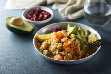 Healthy quinoa bowl with shrimps and avocado