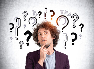 Businessman pensive and concentrated look, set of question marks