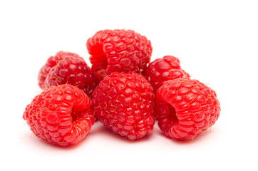 Appetizing red raspberries close up on white background