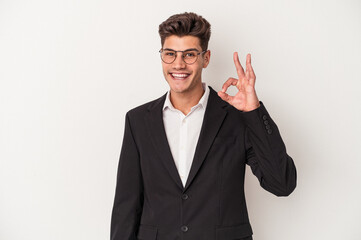 Young business caucasian man isolated on white background cheerful and confident showing ok gesture.