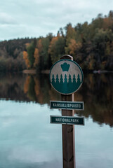 Nationalpark sign in Finnish and English. Nuuksio nationalpark in Finland. Autumn season and...