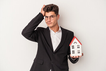 Young real estate caucasian agent isolated on white background being shocked, she has remembered...