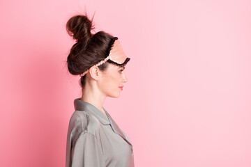 Side profile photo portrait of girl in pajama looking blank space smiling isolated on pastel pink color background