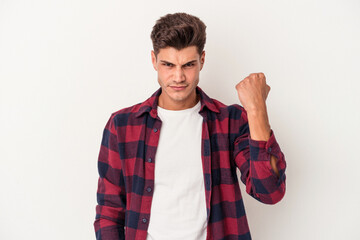 Young caucasian man isolated on white background showing fist to camera, aggressive facial...