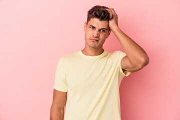 Young caucasian man isolated on pink background tired and very sleepy keeping hand on head.
