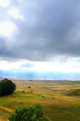 Fototapeta na wymiar Curvy hills and cloudy sky. Montenegro 