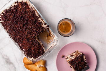 Top view of gourmet Tiramisu italian with a cup of coffee and a piece of cake served with copy space. Classic italian recipe.