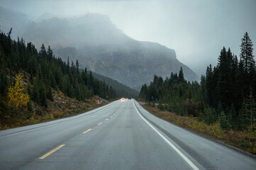 Asphalt road with Rocky mountains in gloomy day on autumn at Banff national park