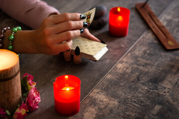 Fortune teller reading a future by tarot cards on rustic table	