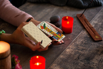 Fortune teller reading a future by tarot cards on rustic table	
