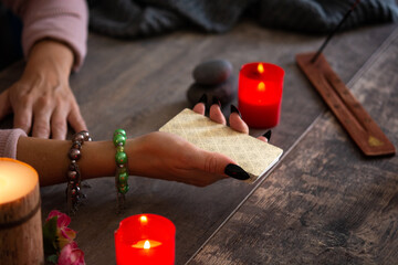 Fortune teller reading a future by tarot cards on rustic table	
