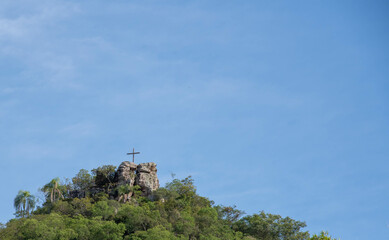 Fototapeta na wymiar Religious monument on top of natural formation.