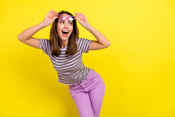 Naklejka premium Photo of lovely millennial brunette lady look empty space wear eyewear t-shirt isolated on yellow background