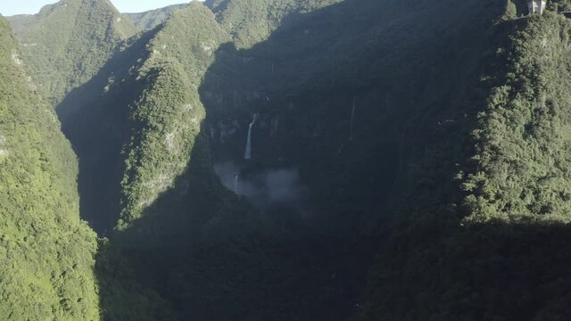 Aerial view of Cascade de La Grande Ravine, a beautiful waterfall among the wild mountains near Saint Benoit, Reunion.