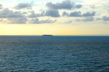 Loaded container ship transports cargo at sea in the evening, English Channel, logistics, economy, shipping, container, ocean freight, transport, shipping company 