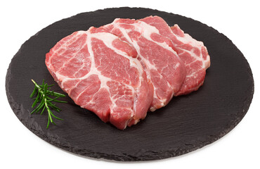 sliced raw pork meat with rosemar on black round stone plate isolated on white background. Clipping path and full depth of field