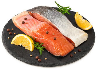 Red fish. Raw salmon fillet with rosemary, peppercorns and lemon on black round stone plate isolate on white background. Clipping path and full depth of field